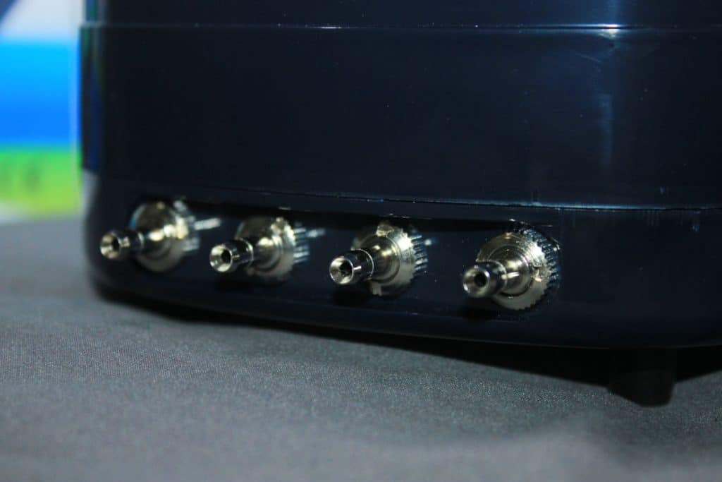 Close up of four aquarium air pump outputs